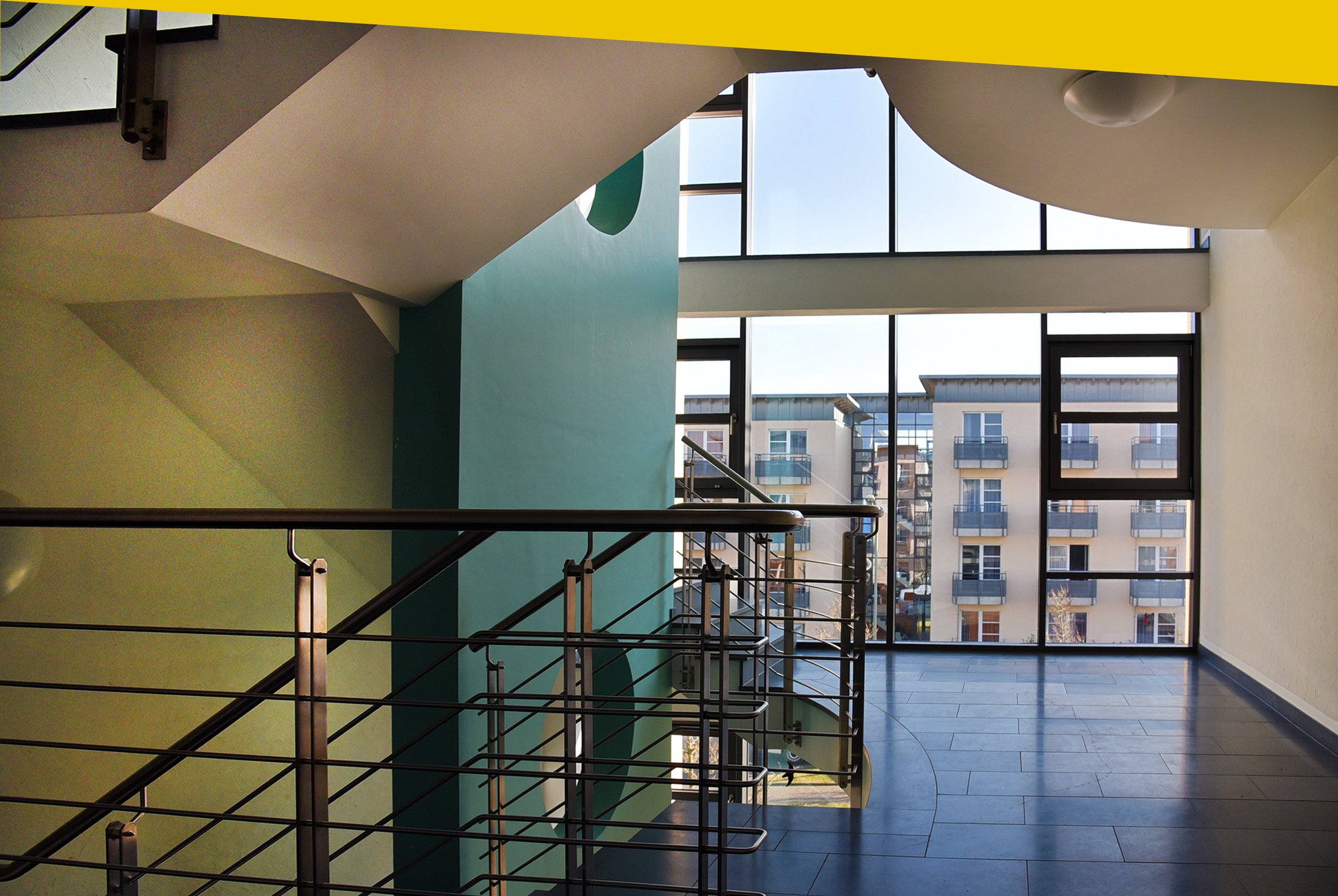 Helle Treppe im Studierendenwohnheim Paderborn-Mersinweg_4, mit großflächigen Fenstern und modernem Design.